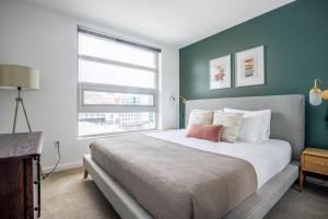 a bedroom with a large bed and a window at SoMa 2BR w Gym Roofdeck nr Pinterest SFO-332 in San Francisco