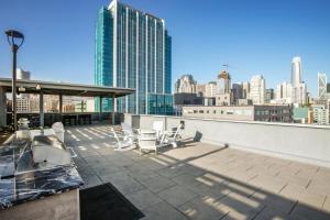 a rooftop patio with chairs and a view of a city at SoMa 2BR w Gym Roofdeck nr Pinterest SFO-332 in San Francisco