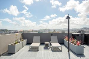 a balcony with chairs and tables on a roof at Hayes Valley Studio w Rooftop WD 1 min to BART SFO-108 in San Francisco