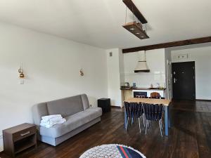 a living room with a couch and a table at apartament 34 in Szczecinek