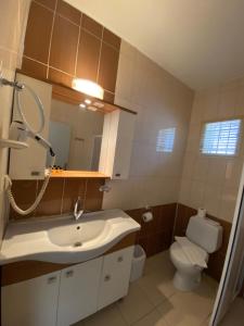 a bathroom with a sink and a toilet at Simsek Hotel in Fethiye