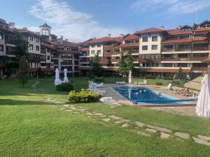 a resort with a swimming pool and some buildings at Bansko Royal Towers Private Apartment V&K in Bansko