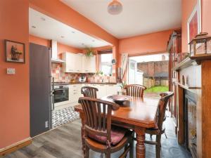 a kitchen with a wooden dining table and chairs at Comfortable Bristol Escape near Gloucester Road in Bristol