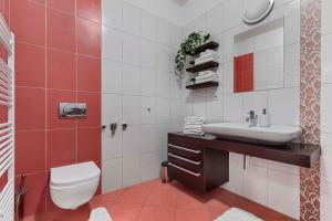 a bathroom with a white toilet and a sink at Charming apartment in the heart of Bratislava in Bratislava