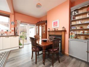 a dining room with a wooden table and chairs at Comfortable Bristol Escape near Gloucester Road in Bristol
