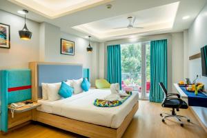 a bedroom with a bed with a desk and a chair at Inde Hotel Sec- 49, Golf Course Extension, Gurgaon in Gurgaon