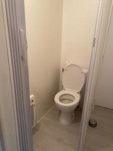 a bathroom with a toilet with the lid up at Maison proche centre-ville in Cholet