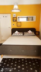 a bedroom with a large bed with a black and white blanket at Apartment&Room Romano in Matulji