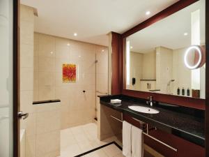 a bathroom with a sink and a shower at Hilton Warsaw City Hotel in Warsaw