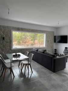 a living room with a couch and a table at Serenity - Brand new apartment in Ermioni Village in Ermioni
