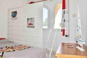 a bedroom with a bed and a desk and a ladder at Villa Isabel- Balcon al Mar- Javea in Jávea