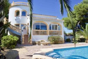 a house with a swimming pool in front of it at Villa Isabel- Balcon al Mar- Javea in Jávea