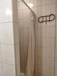a wedding dress hanging on a rack in a shower at Pokój 315 dla dwóch osób z prywatną łazienką - Piotrkowska 262-264 in Łódź +1 photo