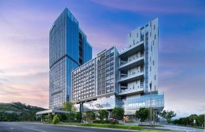 two tall glass buildings next to a street at EVEN Hotels Shenzhen Guangming Cloud Park, an IHG Hotel in Shenzhen