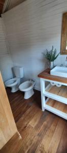 a bathroom with two toilets and a sink at La Luisa in Balneario Reta +15 photos