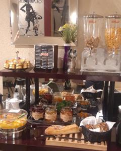 a table with a bunch of different types of food at Hotel Best Western Anjou Lafayette in Paris