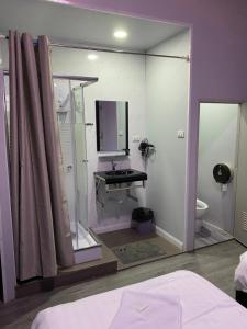 a bathroom with a mirror and a sink and a toilet at Mekong Riverside in Vientiane