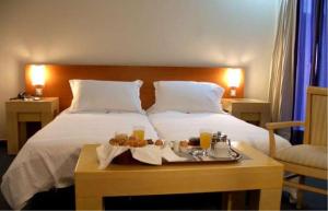Habitación de hotel con cama y bandeja de comida en Dorian Inn - Sure Hotel Collection by Best Western, en Atenas