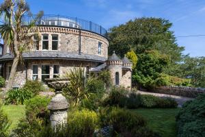 an old stone house with a round roof at The Round House - Panoramic views of Devon's Coast and Country in Ilfracombe