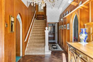 a staircase in a home with wooden walls and wooden floors at The Round House - Panoramic views of Devon's Coast and Country in Ilfracombe