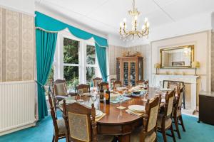 a dining room with a table and chairs and a fireplace at The Round House - Panoramic views of Devon's Coast and Country in Ilfracombe