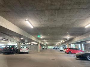 a parking lot with cars parked in a parking garage at Apartment Vito in Vantaa
