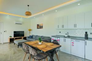 a kitchen and living room with a table and a couch at Villa Sincap in Fethiye