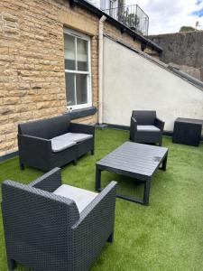 a patio with four chairs and a table and chairs at Luxury Apartment - Great Location in Ecclesall