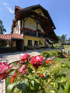 a house with a bunch of flowers in front of it at Zlatiborski Kutak in Zlatibor