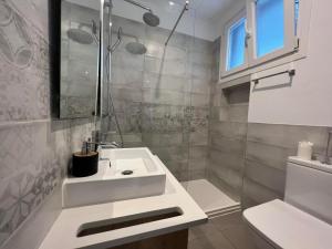 a white bathroom with a sink and a shower at 2BR 2BA with private patio your serene escape in Gibraltar