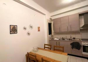 - une cuisine avec une table, des chaises et un évier dans l'établissement Διαμερίσμα με 1 κρεβατοκάμαρα και ένα σαλόνι, à Athènes