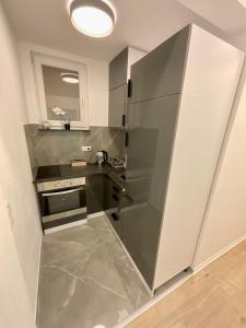 a small kitchen with a stainless steel refrigerator at Elegante Wohnung mit Charme am Marktplatz - 3Z - nähe Frankfurt am Main & Hanau in Nidderau