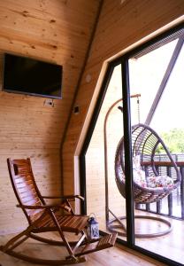 a rocking chair in a room with a screened in porch at Panorama Racha in Ambrolauri