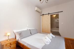 a bedroom with a bed with white pillows on it at Evaxenia's House Old Town Rhodes in Rhodes Town