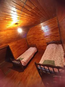 an overhead view of two beds in a wooden room at MOUNTAIN HOUSE in Roshka