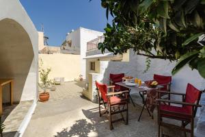 a patio with a table and chairs in a building at Evaxenia's House Old Town Rhodes in Rhodes Town