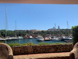 a view of a marina with boats in the water at Sardegna Beach Cala Reale in Santa Marinella