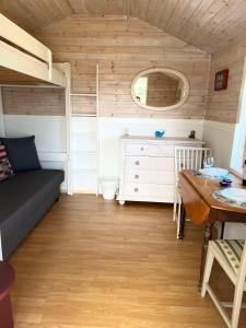 a small room with a bed and a table at Sea view chalet in Hjälteby
