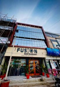 a building with a fusion restaurant in front of it at Hotel Fusion in Kurukshetra