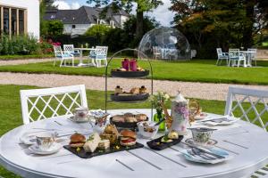 a table with a plate of food on it at Kincraig Castle Hotel in Invergordon