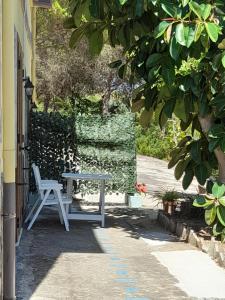 una mesa y una silla sentadas fuera de una casa en Villa Filomena, en Montecorice