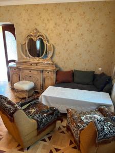 a living room with a bed and a mirror at Erik in in Tbilisi City