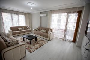 a living room with two couches and a table at Korkmaz Apart in Trabzon