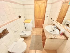 a bathroom with a toilet and a sink at Casa Cecilia in Playa de San Juan +14 photos