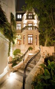 a large house with stairs in front of it at Zapiola Palace - Mansión de 450 mt2 en Belgrano R in Buenos Aires