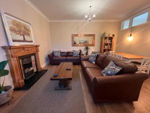 a living room with a couch and a fireplace at The Annex at Merley Mews in Poole