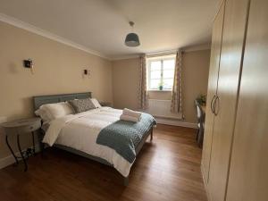 a bedroom with a bed and a window at The Annex at Merley Mews in Poole
