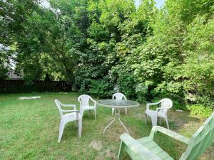 three chairs and a table in a yard at Private Suite in Forest Hill with full kitchen and parking in Toronto