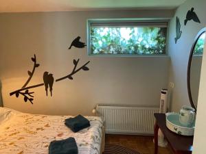 Schlafzimmer mit einem Bett mit Fledermäusen an der Wand in der Unterkunft Ivy Cottage near Amsterdam in Oudendijk