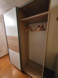 a closet with a mirror and some hangers at Zimmer in einer privaten Wohnung in Schaffhausen